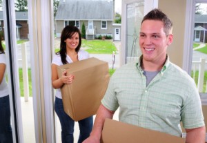 Couple taking boxes in doors - Moving Service