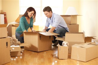 Couple packing boxes for their move